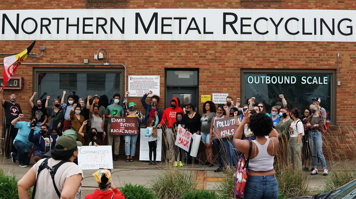Community members protest Northern Metals using a restraining order and community power.